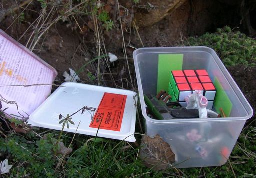 Example of a typical geocache in plastic container.